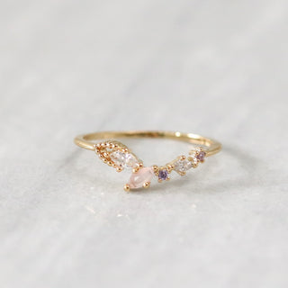 Statement Grey Dove ring with blush pink, lavender, and clear marquise crystals on a gold-plated brass band.